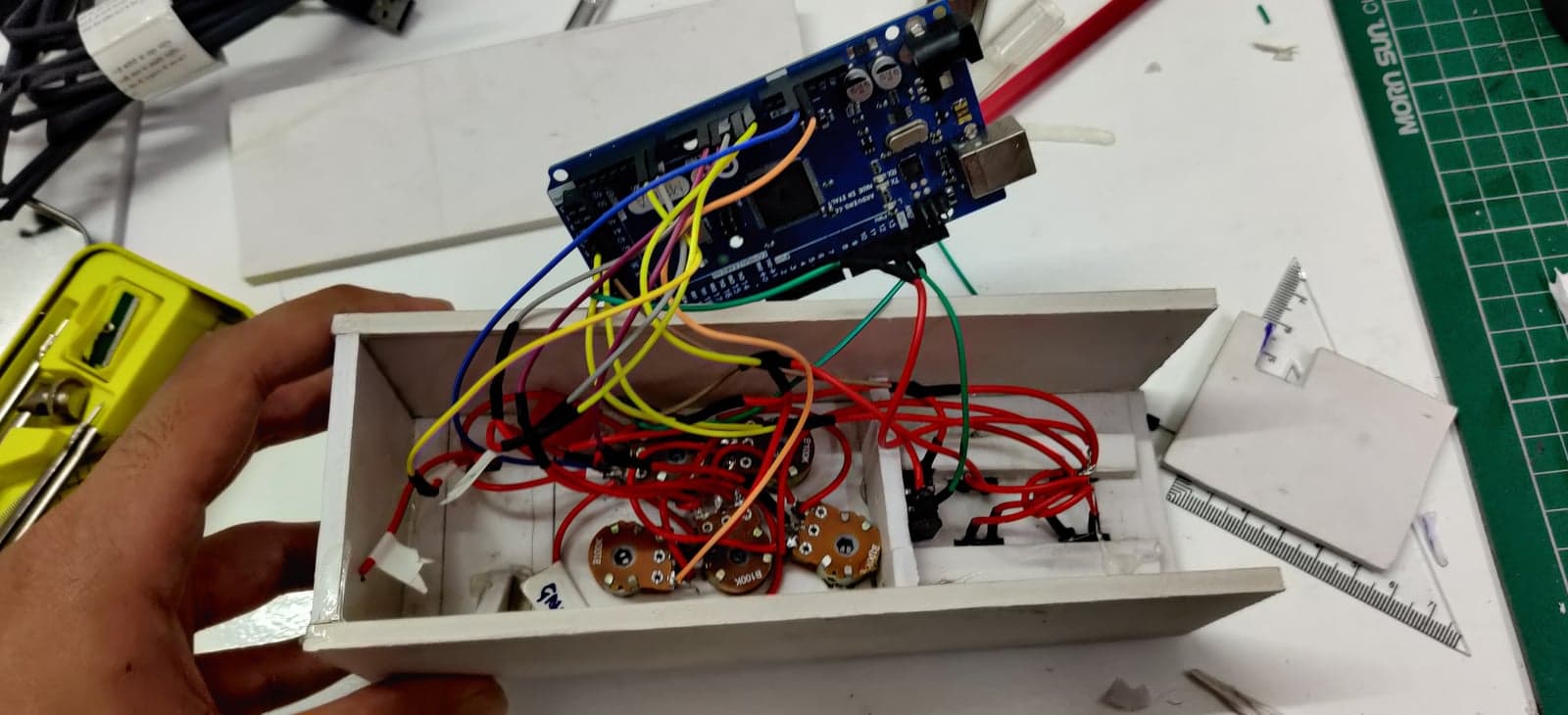The open case with the Arduino Mega wired to the knobs and switches