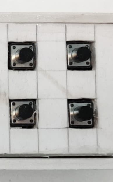The 2×2 grid of tactile switches